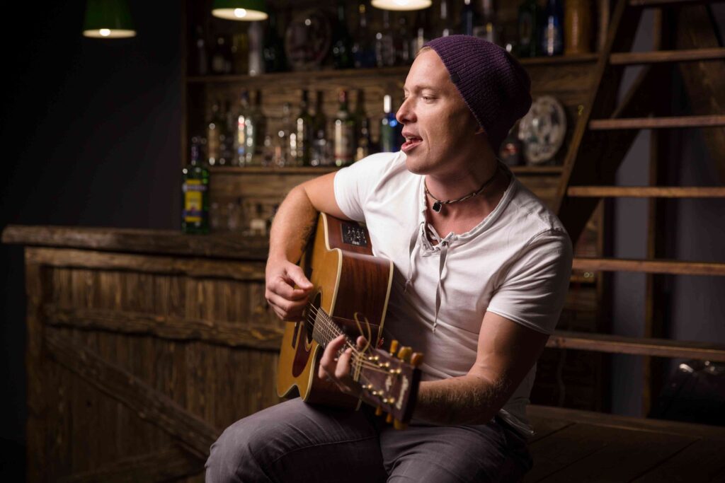 Man singing and playing the guitar